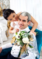 Cheerful married couple in white room